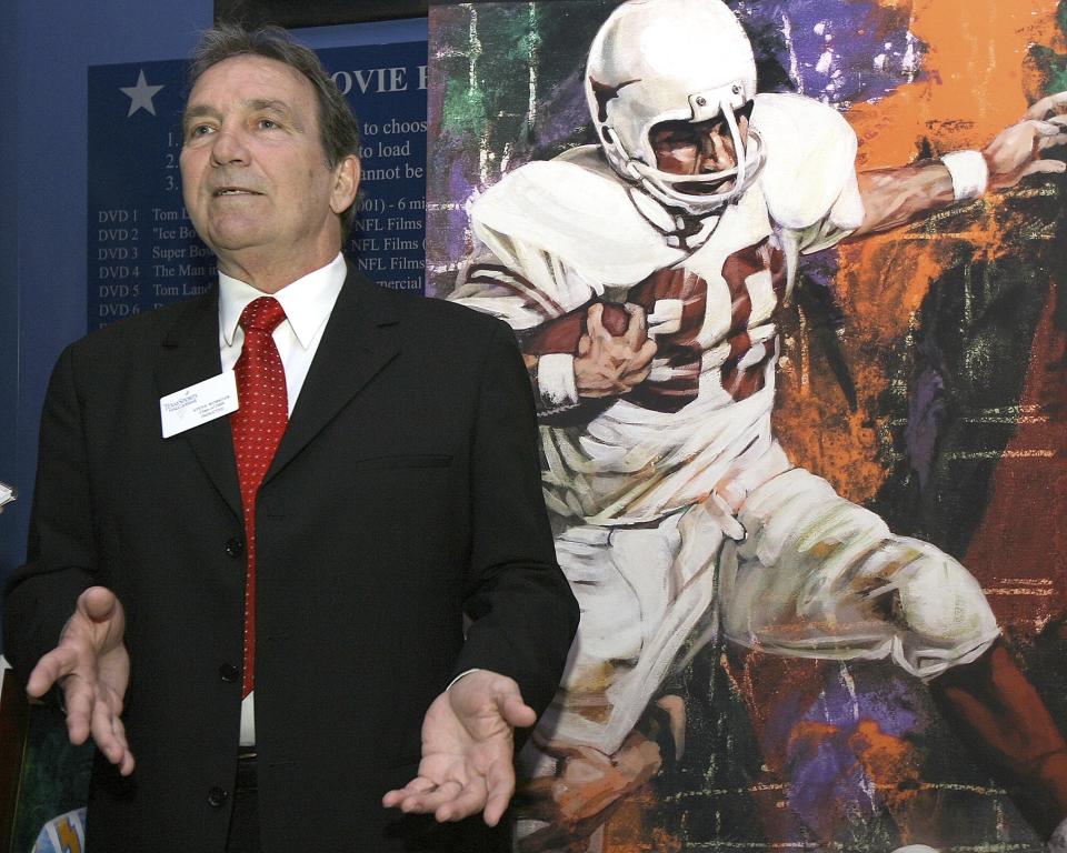 FILE - Former Texas fullback Steve Worster stands in front of a painting of himself while talking with reporters during induction ceremonies at the Texas Sports Hall of Fame on Wednesday, March 4, 2009, in Waco, Texas. Worster, the powerful fullback in a bruising wishbone offense that led Texas to the undisputed national championship in 1969 and the brink of another a year later, died Aug. 13, 2022, the school announced. He was 73. (Duane A. Laverty/Waco Tribune-Herald via AP, File)