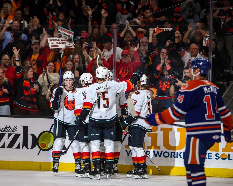 Coachella Valley Firebirds players celebrate a goal by defenseman Cale Fleury during the third period of their opening night game at Acrisure Arena in Palm Desert, Calif., Friday, Oct. 13, 2023.