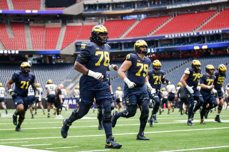 Michigan players warm up during open practice at NRG Stadium in Houston on Saturday, Jan. 6, 2024.