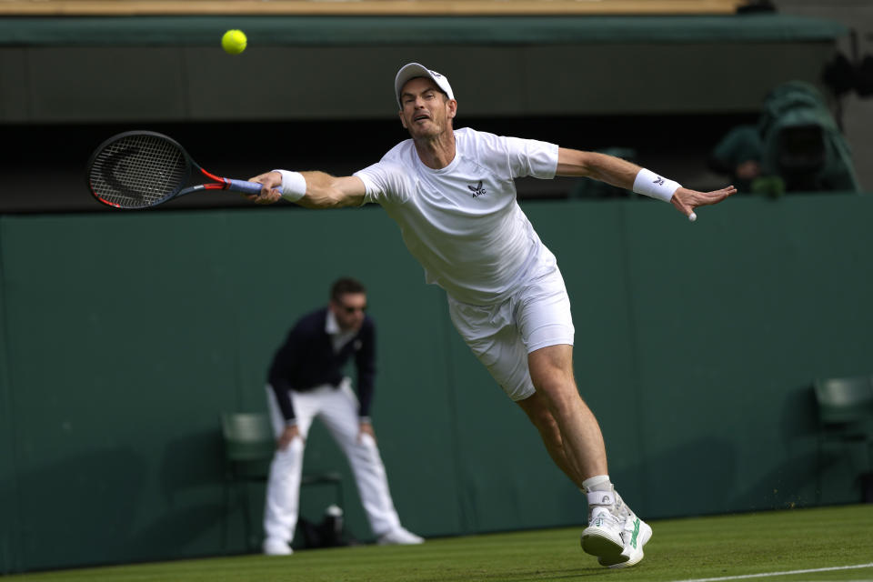 Britain's Andy Murray returns the ball to John Isner of the US during their singles tennis match on day three of the Wimbledon tennis championships in London, Wednesday, June 29, 2022. (AP Photo/Alastair Grant)