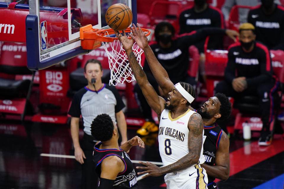 New Orleans Pelicans' Naji Marshall, center, goes up for a shot between Philadelphia 76ers' Joel Embiid, right, and Tobias Harris during the second half of an NBA basketball game, Friday, May 7, 2021, in Philadelphia. (AP Photo/Matt Slocum)