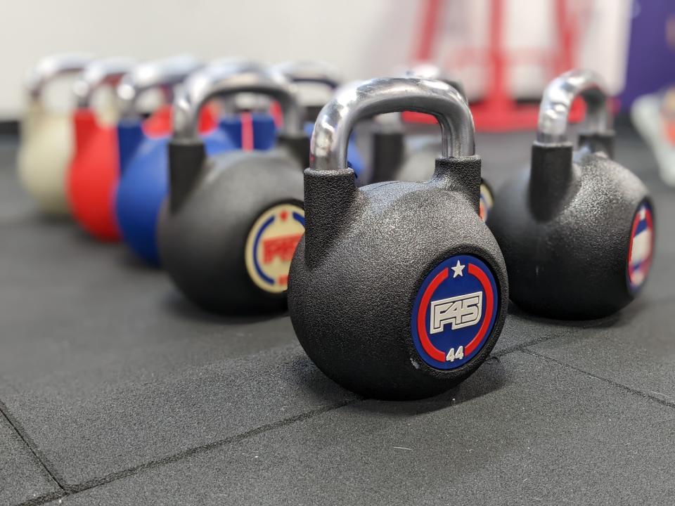 <p>A picture from the Pixel 6a's camera, featuring two rows of colorful kettlebells with the background blurred.</p>
