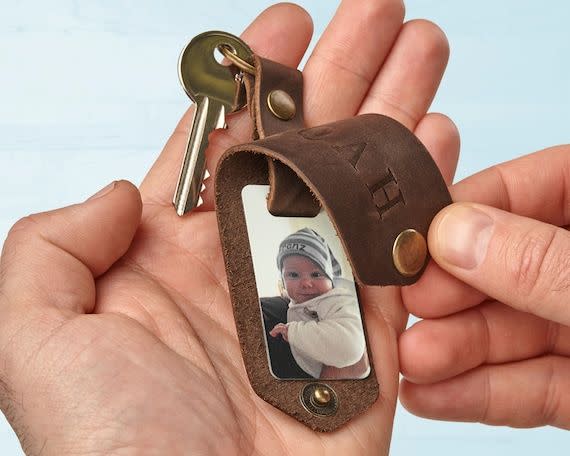 <p><strong>TimelessLeatherShop</strong></p><p>etsy.com</p><p><strong>$19.50</strong></p><p>Engrave the front of this leather keychain with your desired text, then add one or two photos inside, so he can admire his favorite people (his kids!) wherever he goes. </p>