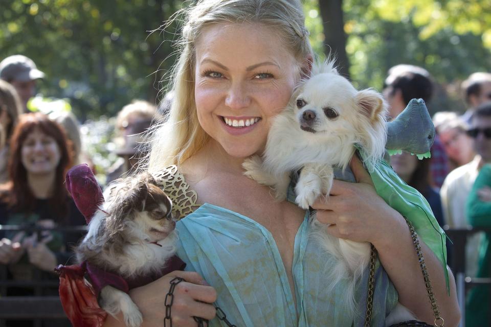 A woman poses for a photo dressed as Daenerys Targaryen from Game of Thrones with her dogs during the 24th Annual Tompkins Square Halloween Dog Parade in New York