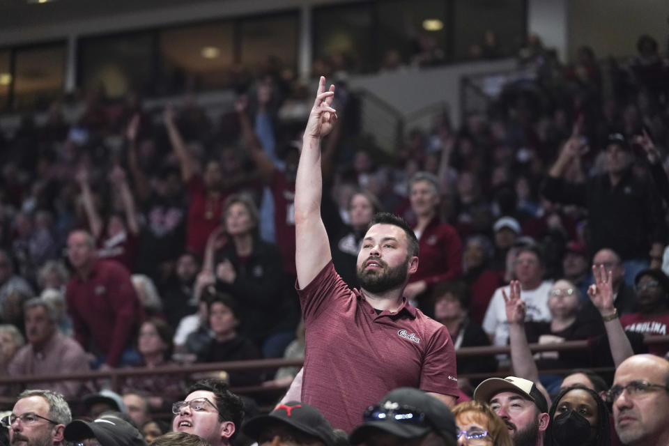 A South Carolina fan reacts to a shot during a second-round college basketball game against South Florida in the NCAA Tournament, Sunday, March 19, 2023, at Colonial Life Arena in Columbia, S.C. South Carolina defeated South Florida 76-45. The women's title game will be broadcast on ABC — the first appearance on network television since 1995. (AP Photo/Sean Rayford)