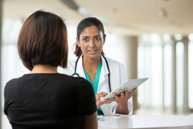 <span class="caption">Doctors focus on individual well-being, others focus on overall health.</span> <span class="attribution"><a class="link " href="https://www.shutterstock.com/image-photo/indian-doctor-talking-female-patient-doctors-110078714?src=OizN584UrwZTc6fCv-z_nA-1-19" rel="nofollow noopener" target="_blank" data-ylk="slk:Stuart Jenner/Shutterstock;elm:context_link;itc:0;sec:content-canvas">Stuart Jenner/Shutterstock</a></span>