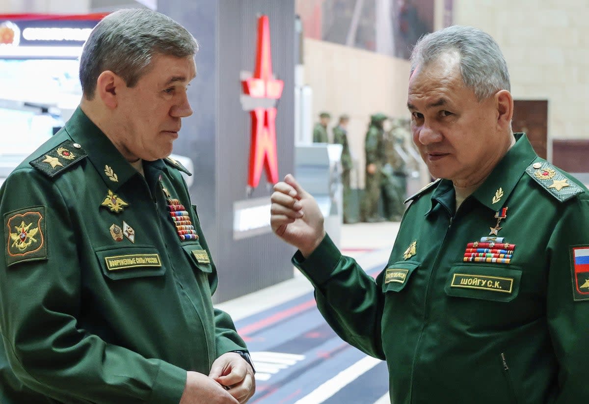 Former Russian defence minister Sergei Shoigu, right, gestures as he speaks to chief of the general staff Valery Gerasimov in Moscow in December 2023  (AP)