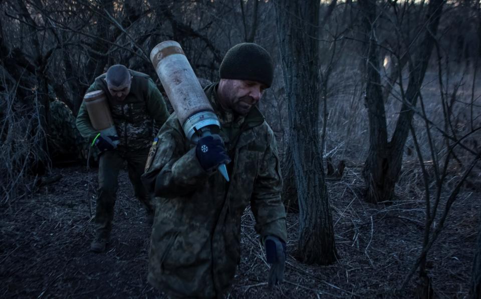 Ukrainian servicemen carry shells for a tank, amid Russia's attack on Ukraine's in Luhansk region