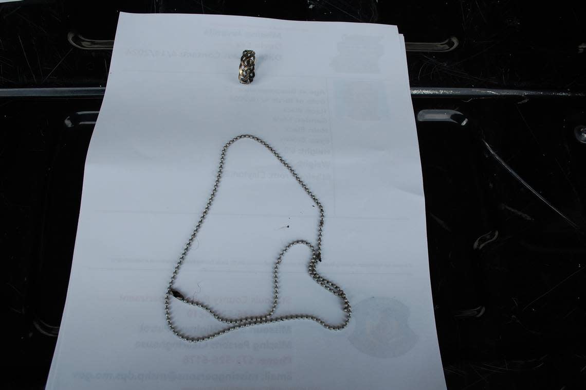 The silver chain and ring found on the body.