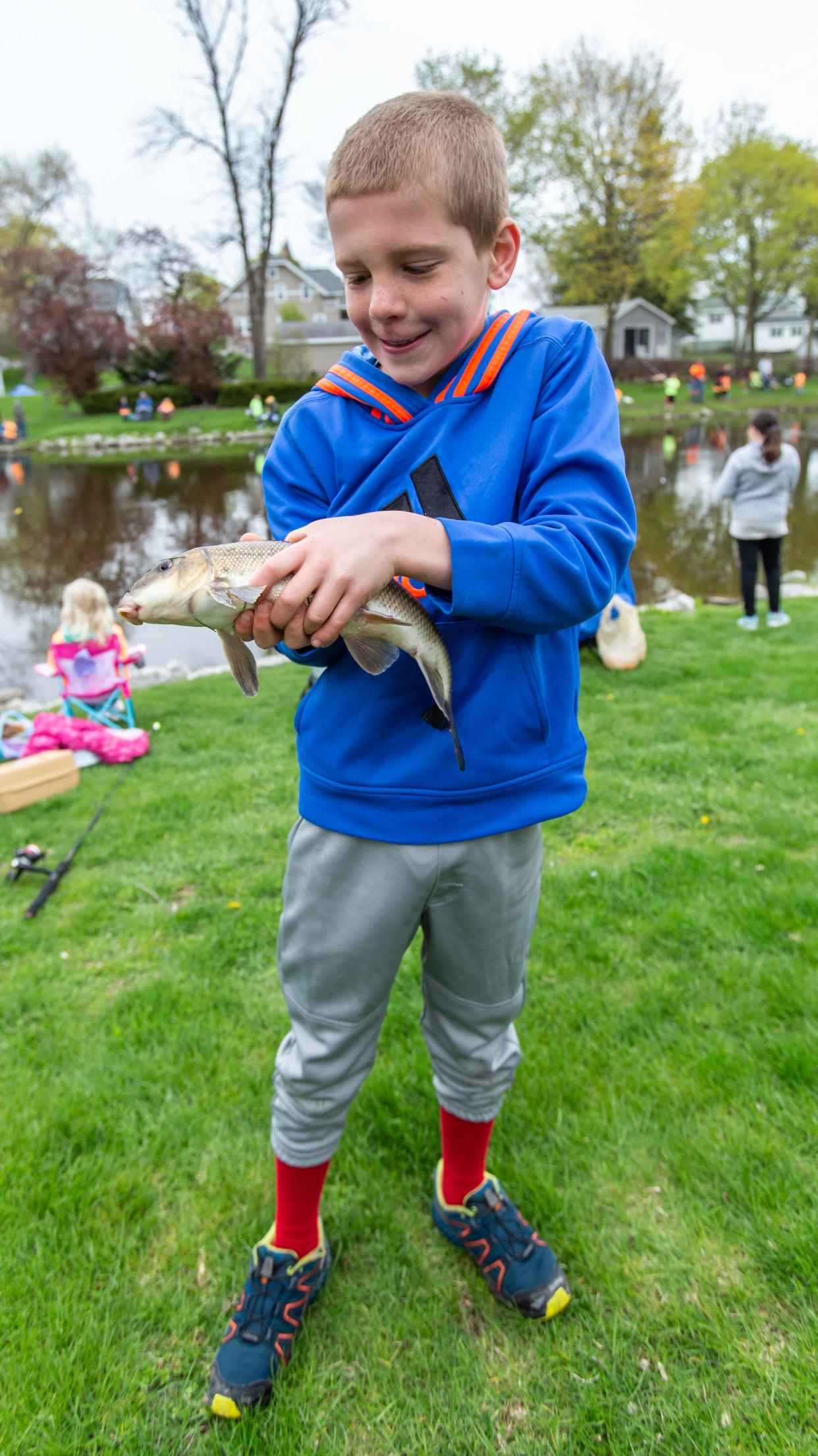 Nine-year-old Isaac Weber of Germantown tries to hold onto his slippery catch during the Kids' Catch and Release Fishing Derby hosted by the Optimist Club of Menomonee Falls on Saturday, May 11, 2019.