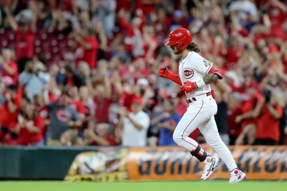 Cincinnati Reds second baseman Jonathan India pumps his fist as he rounds the bases after hitting a two-run homer during a Sept. 3, 2021 game.