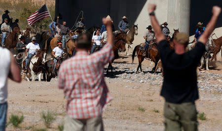 FILE PHOTO: Protesters cheer on horseback riders as they herd cattle that belongs to rancher Cliven Bundy after they were released near Bunkerville, Nevada, U.S. April 12, 2014. REUTERS/Jim Urquhart/File Photo
