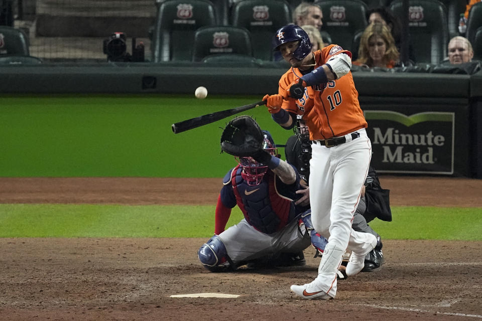Houston Astros' Yuli Gurriel hits a home run against the Boston Red Sox during the ninth inning in Game 2 of baseball's American League Championship Series Saturday, Oct. 16, 2021, in Houston. (AP Photo/Sue Ogrocki)