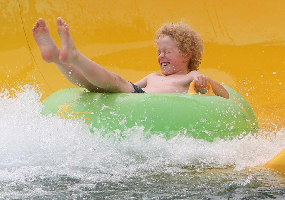 Calvin Dennis, 9, takes a ride on one of the slides at Water Works Park in Cuyahoga Falls.