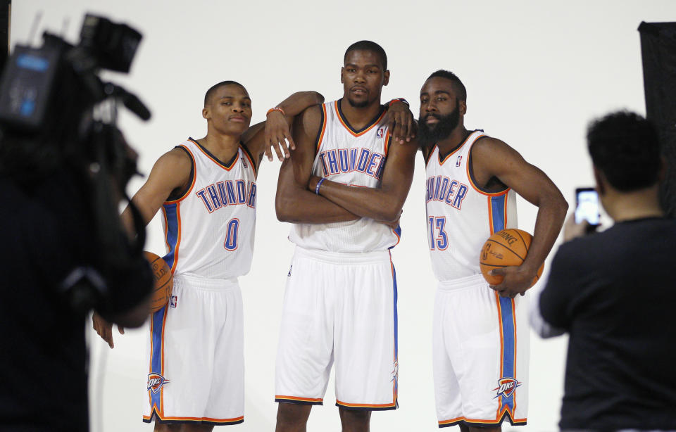 FILE - In this Dec. 13, 2011, file photo, Oklahoma City Thunder's Russell Westbrook (0), Kevin Durant, center, and James Harden (13) pose for a photo for NBA basketball photographers during media day in Oklahoma City. The Thunder are heading into a major transition. Westbrook was the last remaining player from the team that moved from Seattle to Oklahoma City in 2008. Durant, Harden, Serge Ibaka, Paul George and others are all gone. Now Westbrook will soon be on his way to Houston after an 11-year career with the franchise. (AP Photo/Sue Ogrocki, File)