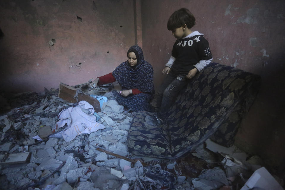 Palestinians salvage their belongings after an Israeli strike in Rafah, Gaza Strip, Sunday, Dec. 24, 2023. (AP Photo/Hatem Ali)