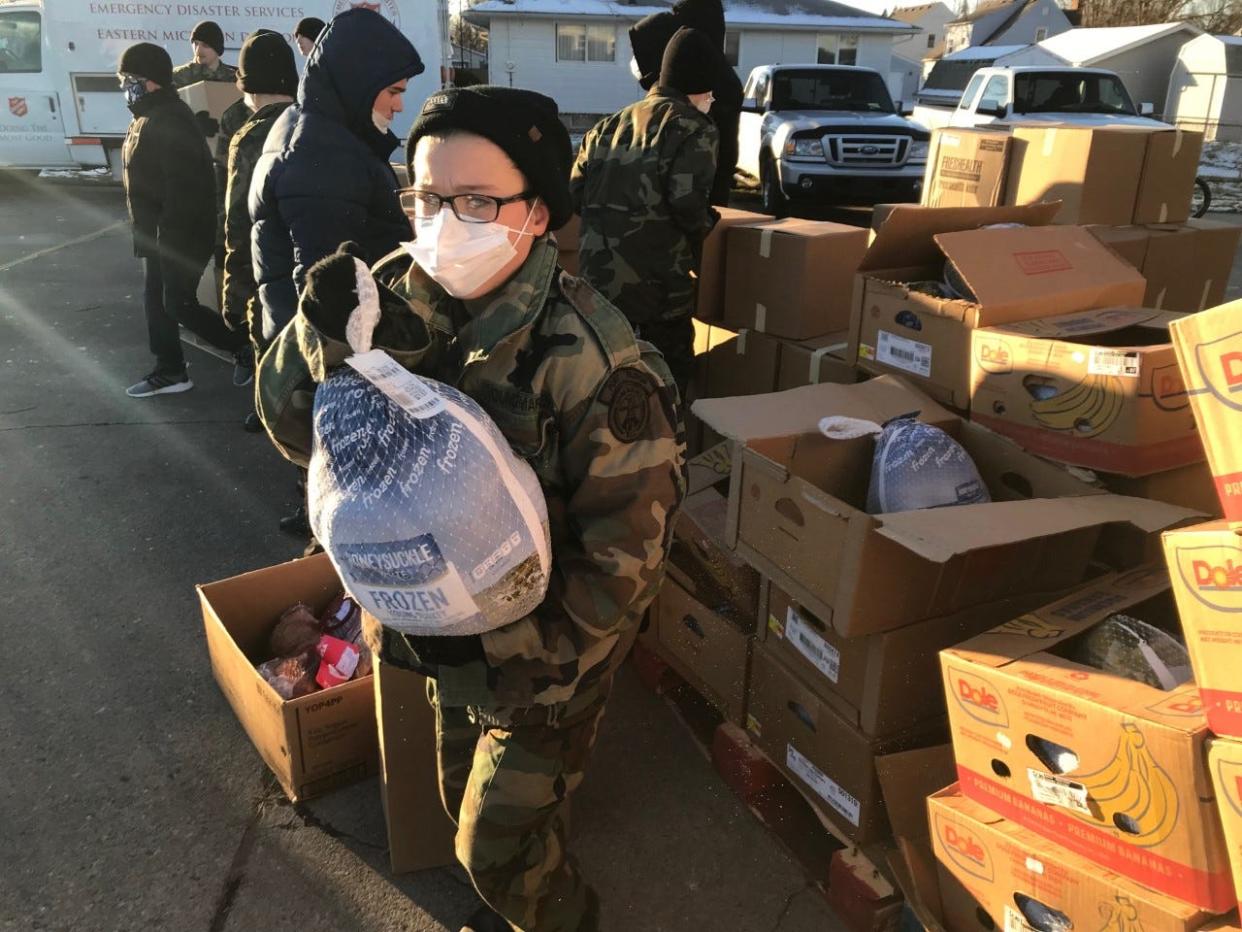 Young Marines load food into people's trunks for the annual Salvation Army distribution day on Wednesday, Dec. 22, 2021.