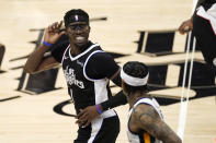 Los Angeles Clippers guard Reggie Jackson, left, smiles as Utah Jazz guard Jordan Clarkson after scoring during the second half of Game 3 of a second-round NBA basketball playoff series Saturday, June 12, 2021, in Los Angeles. (AP Photo/Mark J. Terrill)