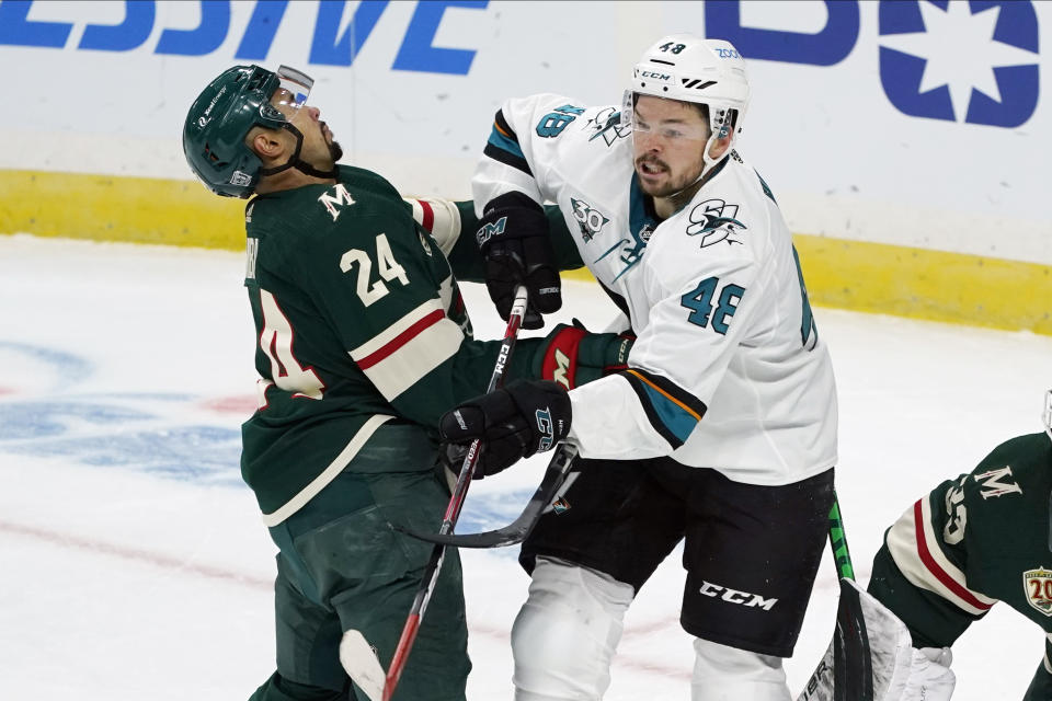 Minnesota Wild's Matt Dumba (24) rears back on a push by San Jose Sharks' Tomas Hertl (48) in the first period of an NHL hockey game, Friday, Jan. 22, 2021, in St. Paul, Minn. (AP Photo/Jim Mone)