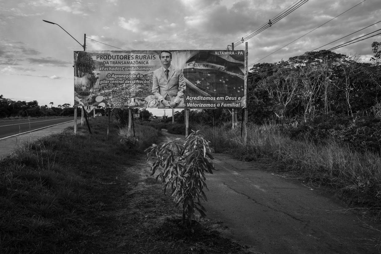 This image provided by World Press Photo, part of a series titled Amazonian Dystopia, by Lalo de Almeida for Folha de Sao Paulo/Panos Pictures which won the World Press Photo Long-Term Project award,, shows A billboard with a message of support to President Bolsonaro stands alongside the Trans-Amazonian Highway, Altamira, Para, Brazil, July 20, 2020. It was financed by local farmers. Agribusiness is one of the president's main pillars of political support (Lalo de Almeida for Folha de Sao Paulo/Panos Pictures/World Press Photo via AP)