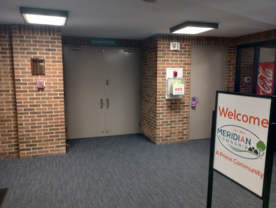 The closed doors of the Meridian Township Municipal Building’s Township Townhall Room April 16, 2024. (WLNS)