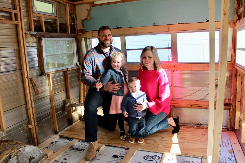 Somerset resident Libby Reilly poses with husband Shane and their kids inside the 1975 Shasta Starflyte trailer that will become home to her upcoming mobile bookstore, Buster's Bookhouse.