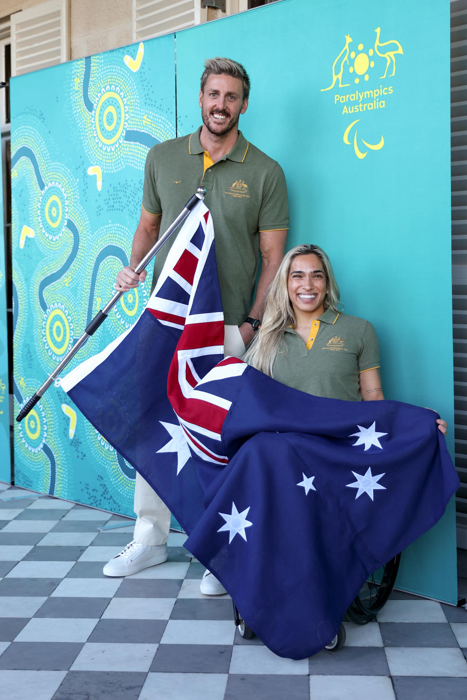 SYDNEY, AUSTRALIA - JULY 12: Madison de Rozario and Brenden Hall pose with the Australian flag during a media opportunity announcing the  Australian Flag Bearers for Paris 2024 Paralympic Opening Ceremony at Admiralty House on July 12, 2024 in Sydney, Australia. (Photo by Brendon Thorne/Getty Images)