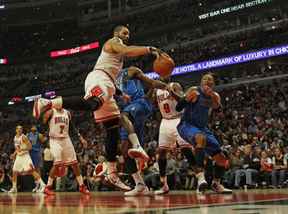 CHICAGO, IL - APRIL 21: Carlos Boozer #5 of the Chicago Bulls grabs a rebound against Ian Mahinmi #28 and Shawn Marion #0 of the Dallas Mavericks at the United Center on April 21, 2012 in Chicago, Illinois. NOTE TO USER: User expressly acknowledges and agress that, by downloading and/or using this photograph, User is consenting to the terms and conditions of the Getty Images License Agreement. (Photo by Jonathan Daniel/Getty Images)