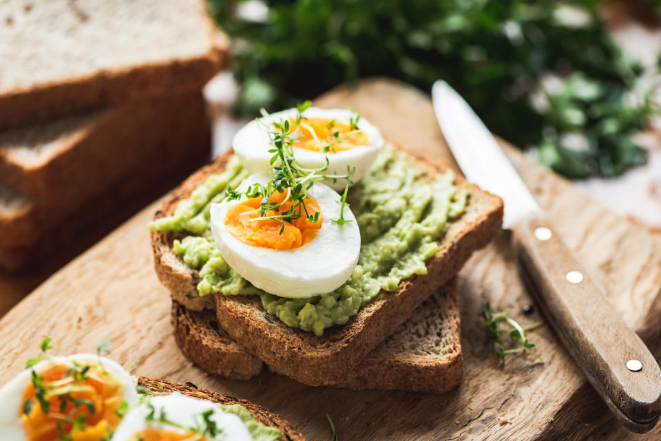 Healhy breakfast toast with avocados and boiled eggs