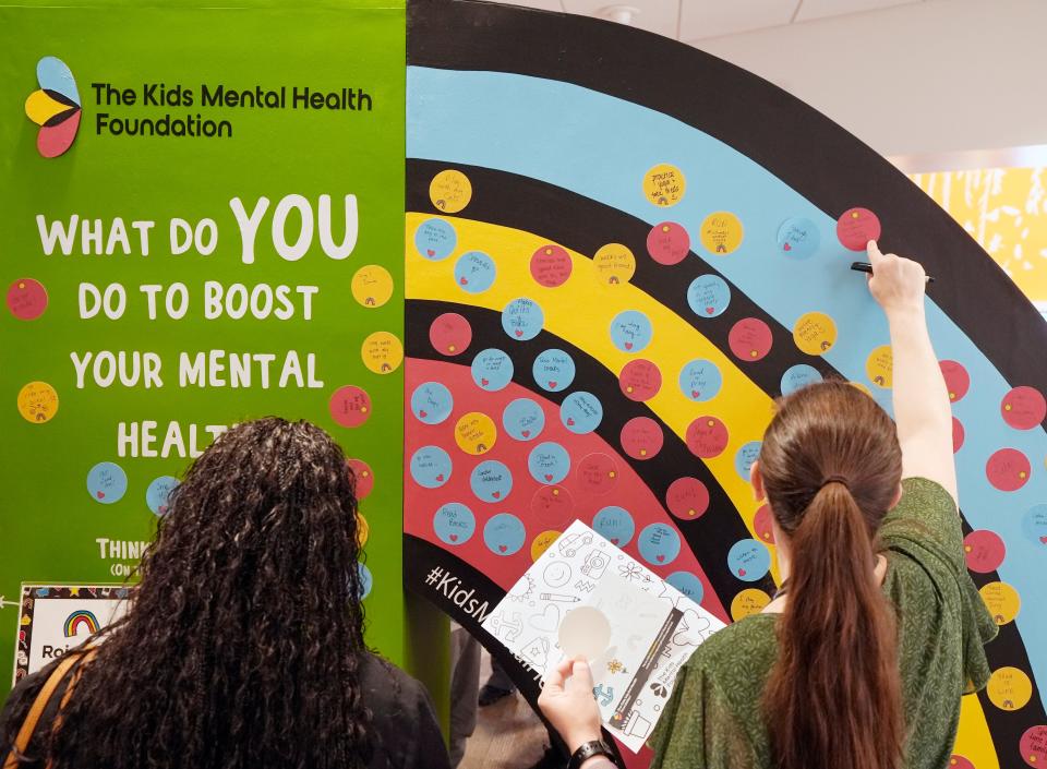 Nationwide Children's Hospital employees add their thoughts to a board of mood-boosting ideas during a mental health break and lunch program the hospital held Tuesday to announce the establishment of its Kids Mental Health Foundation.