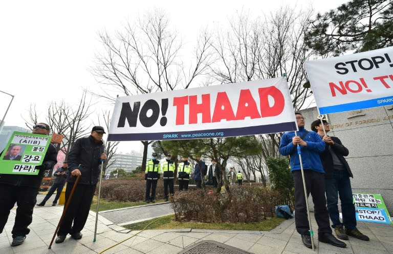 Anti-war activists hold a banner demonstrating against the Terminal High Altitude Area Defense (THAAD) anti-ballistic missile system outside the Foreign Ministry in Seoul on March 17, 2015