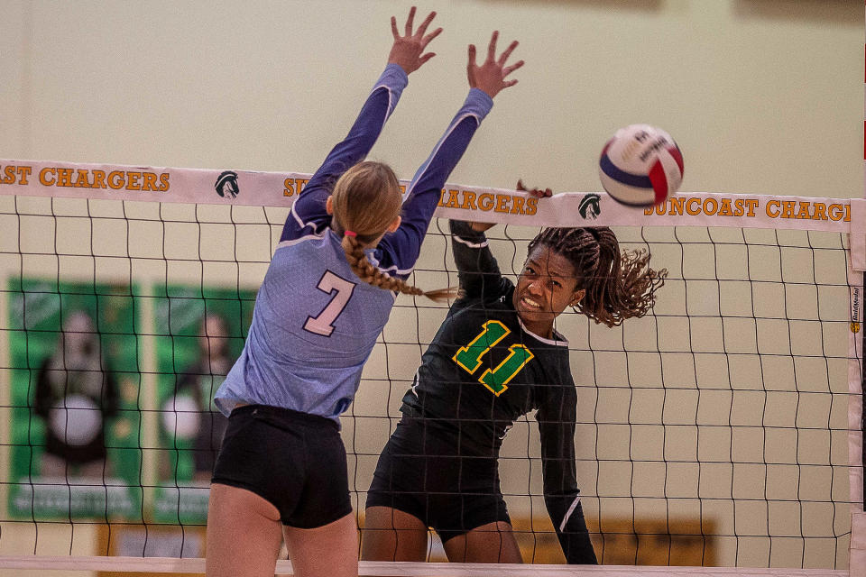 Lyla Buser (7) jumps to block McKayla Theleus (11) as the Suncoast Community High School Chargers hosted the Dr. Joaquin Garc’a Bulldogs for the District 14-5A volleyball tournament championship at the school in Riviera Beach, Fla., on October 19, 2023. In their first year with a team, the Bulldogs won the match in five games.