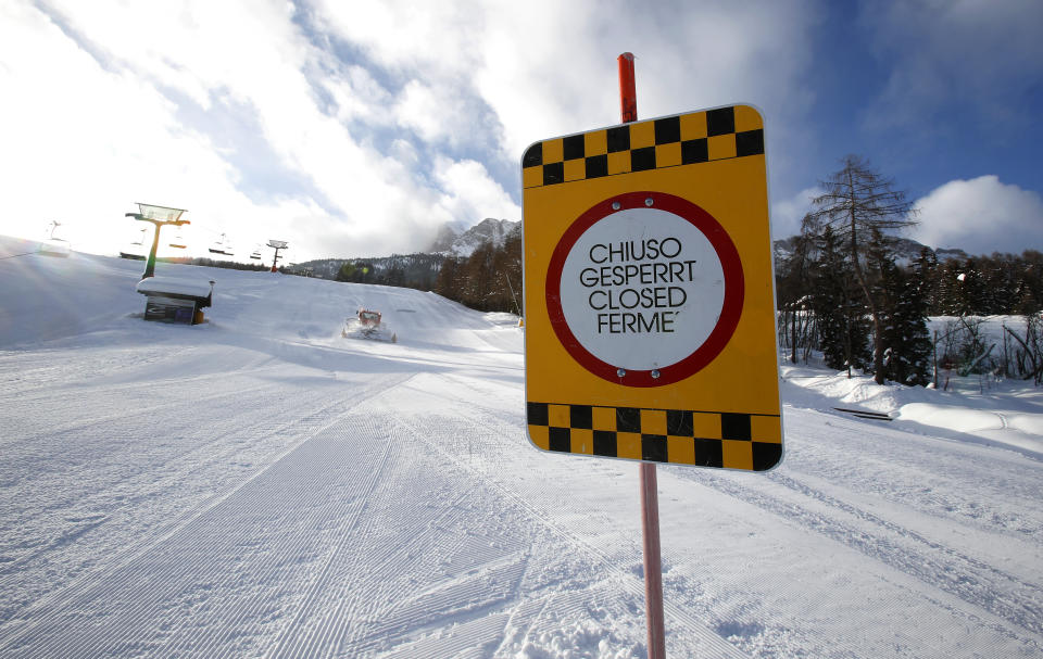 FILE - In this Jan. 28, 2021 file photo, a sign marks the closed ski slope in Cortina D'Ampezzo , Italy. On the eve of what was supposed to finally be the repeatedly delayed opening of Italy’s ski slopes, the government on Sunday, Feb. 14, 2021, yanked permission because a coronavirus variant was found to be circulating in a good portion of recently infected persons. Health Minister Roberto Speranza’s ordinance forbids amateur skiing at least until March 5. (AP Photo/Antonio Calanni)