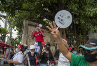 Pro-democracy demonstrators shout slogans during a protest outside the Parliament in Bangkok, Thailand, Thursday, Sept. 24, 2020. Lawmakers in Thailand are expected to vote Thursday on six proposed amendments to the constitution, as protesters supporting pro-democratic charter reforms gathered outside the parliament building. (AP Photo/Gemunu Amarasinghe)