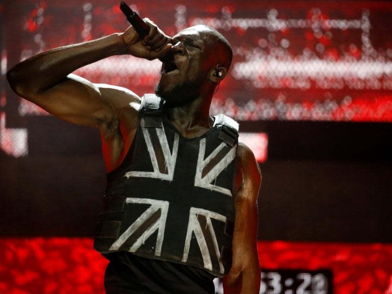 The Union Jack-emblazoned stab vest worn by Stormzy during his headline slot at Glastonbury was designed by Banksy, the artist has revealed.In a post on Instagram, Banksy wrote: “I made a customised stab-proof vest and thought – who could possibly wear this? Stormzy at Glastonbury.”Stormzy shared the post on Twitter, adding the caption: ”Absolutely f****** speechless.”The 25-year-old rapper said his headline slot on the Pyramid Stage on Friday was “the greatest night of my entire life”. The set, which aired live on the BBC, saw the crowd chant along to the words “F**k Boris”, in reference to Boris Johnson, the frontrunner to succeed Theresa May as the prime minister of the UK. The statement is part of the lyrics to the rapper’s track “Vossi Bop”, released in April of this year, which sees him declare: “I’ll never die, I’m Chuck Norris/F**k the government and f**k Boris”. It was one of the few overtly political statements of the set, although The Independent‘s Jazz Monroe wrote: “But to look for outright polemic misses the point. From the disarming ballet suite to footage of grainy street spats on the video screen, the set seeks to erase the binary between those people of colour deemed, by the ruling class, to be acceptable and those not.”> View this post on Instagram> > . I made a customised stab-proof vest and thought – who could possibly wear this? Stormzy at Glastonbury.> > A post shared by Banksy (@banksy) on Jun 29, 2019 at 6:41am PDT> Absolutely fucking speechless pic.twitter.com/TmEGCKrewl> > — CROWN OUT NOW 👑 (@stormzy) > > June 29, 2019“Some illustrious guests (Dave and Fredo also feature) and a buttoned-up live band can’t hide that this set was pure, uncompromising Stormzy – a grime masterclass from an astonishingly versatile performer who, it seems, can do anything he pleases.” Glastonbury continues today with sets from Janet Jackson, Johnny Marr, Chemical Brothers, Maggie Rogers, Lewis Capaldi, Liam Gallagher, and The Killers.