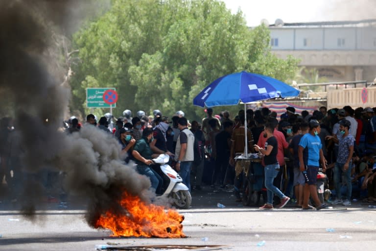 Protesters burn tyres during a demonstration against unemployment and a lack of basic services, in the southern Iraqi city of Basra on July 15, 2018