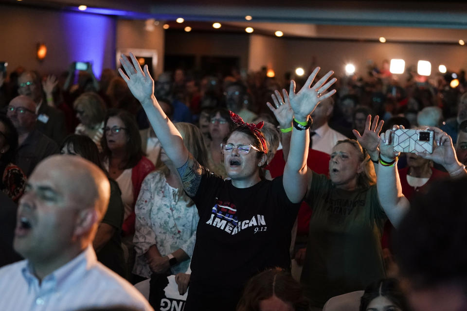 FILE - Members of the audience sing songs of worship during a primary night election celebration in Chambersburg, Pa., Tuesday, May 17, 2022, for state Sen. Doug Mastriano's, R-Franklin, the Republican candidate for governor of Pennsylvania. (AP Photo/ Carolyn Kaster, File)