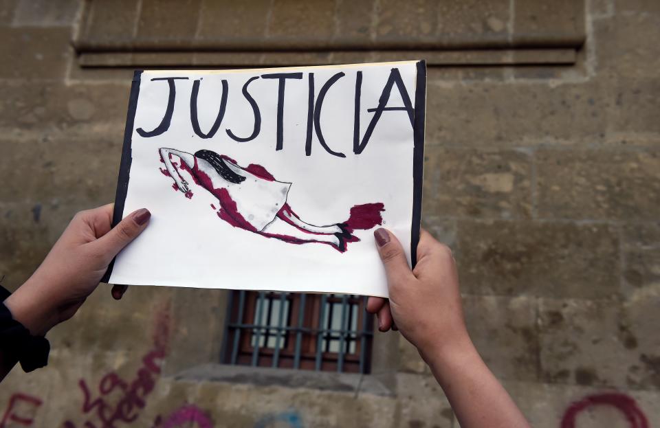 Demonstrators gather outside the National Palace, in Mexico City, on February 18, 2020, to protest gender violence. - Dozens of women protested Tuesday over the murder of a seven-year-old girl in the Mexican capital, a case that generated anger and outrage in a country used to violence. The murder of the minor shocked the country two days after hundreds of women protested in several cities in Mexico over the femicide of Ingrid Escamilla, a 25-year-old woman who was killed by her partner north of the Mexican capital. (Photo by ALFREDO ESTRELLA / AFP) (Photo by ALFREDO ESTRELLA/AFP via Getty Images)