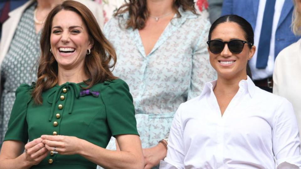 Kate Middleton and Meghan Markle enjoy a match at Wimbledon last year. (Image via Getty Images)