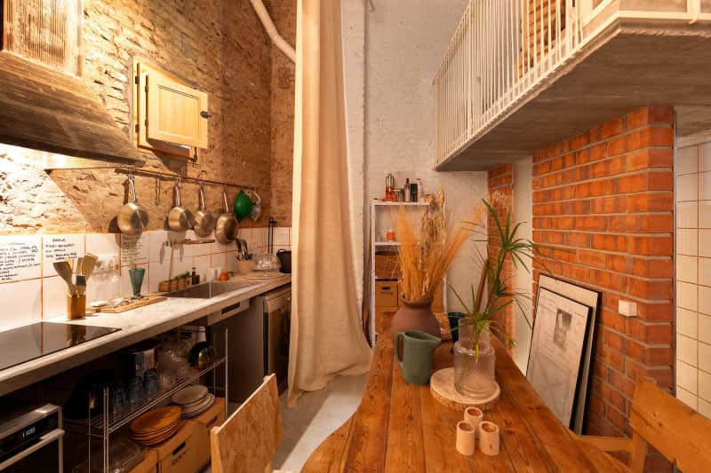 Kitchen with exposed brick and wood table and chairs