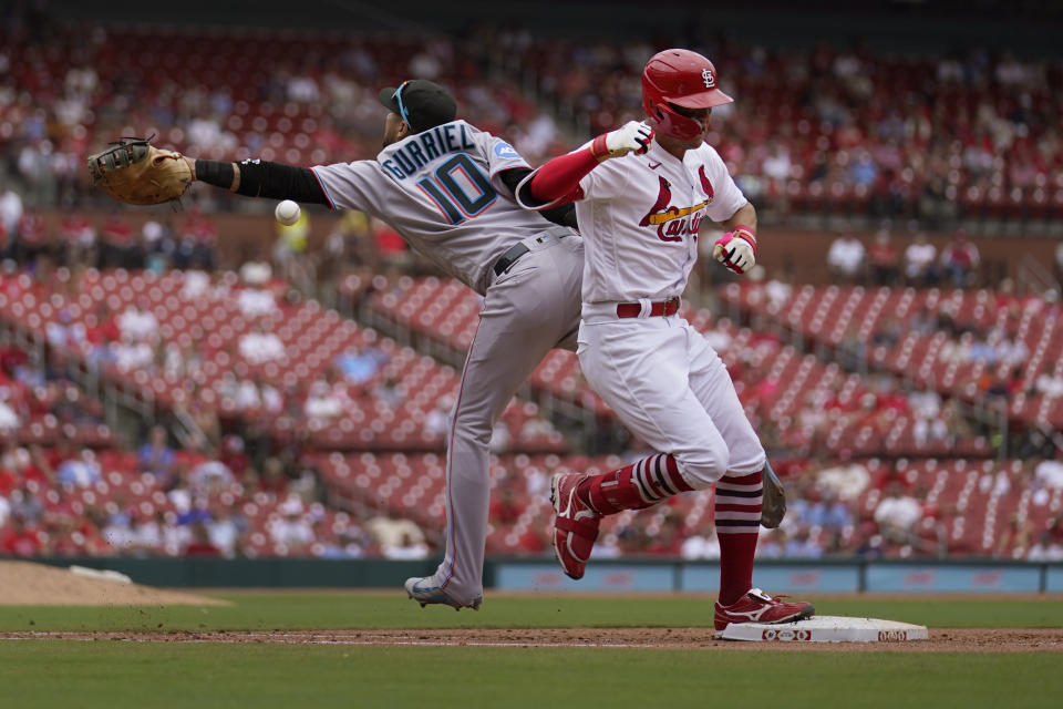 St. Louis Cardinals' Lars Nootbaar, right, is safe at first for an RBI single as the throw gets past Miami Marlins first baseman Yuli Gurriel during the seventh inning of a baseball game Wednesday, July 19, 2023, in St. Louis. Nootbaar went on to third on the throwing error by Marlins third baseman Jon Berti. (AP Photo/Jeff Roberson)