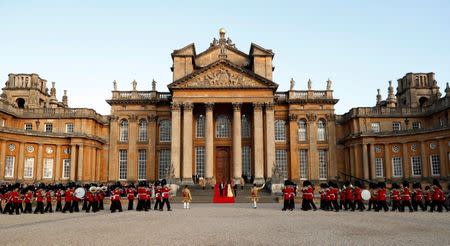 British Prime Minister Theresa May and her husband Philip stand together with U.S. President Donald Trump and First Lady Melania Trump at the entrance to Blenheim Palace, where they are attending a dinner with specially invited guests and business leaders, near Oxford, Britain, July 12, 2018. REUTERS/Kevin Lamarque