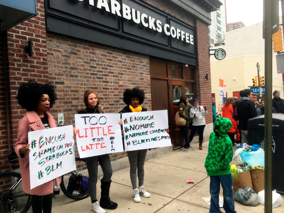 Protesters gather outside a Starbucks in Philadelphia, Sunday, April 15, 2018, where two black men were arrested Thursday after Starbucks employees called police to say the men were trespassing. 
Now LA Fitness has apologized to two black men who claim to have been racially profiled at one of its clubs.