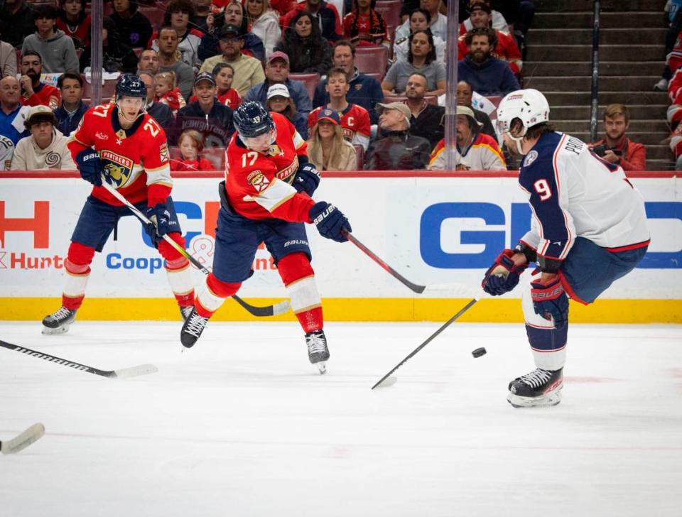 Florida Panthers center Evan Rodrigues (17) takes a shot on goal passed Columbus Blue Jackets defenseman Ivan Provorov (9) during the first period of a hockey game on Thursday, April 11, 2024, at Amerant Bank Arena in Sunrise, Fla.