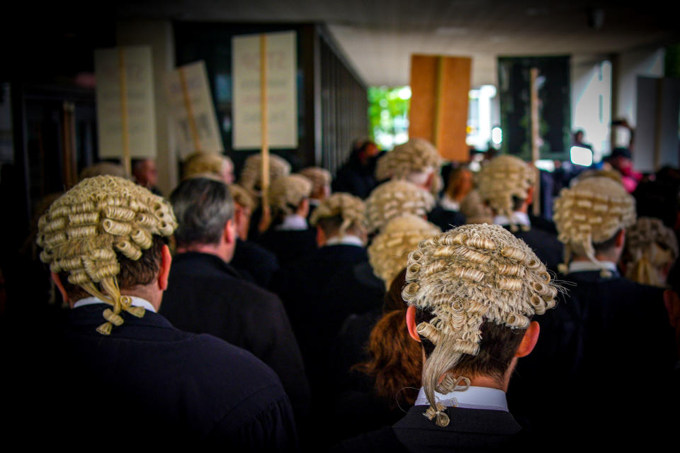 Criminal barristers from the Criminal Bar Association (CBA), which represents barristers in England and Wales, outside Manchester Crown Court on the first of several days of court walkouts by CBA members in a row over legal aid funding.Picture date: Monday June 27, 2022.