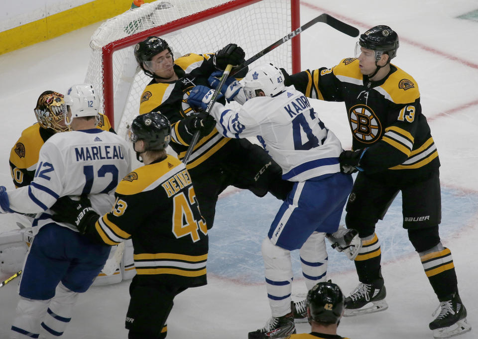 Boston Bruins defenseman Connor Clifton (75) and Toronto Maple Leafs center Nazem Kadri (43) shove each other at the goal during the third period of Game 2 of an NHL hockey first-round playoff series, Saturday, April 13, 2019, in Boston. (AP Photo/Mary Schwalm)