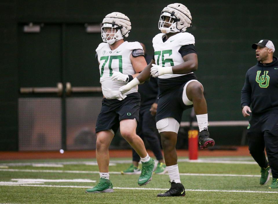 Oregon offensive linemen Charlie Pickard, left, and Josh Conerly Jr. work out during practice with the Ducks Thursday, April 20, 2023 at the Moshofsky Center in Eugene, Ore.