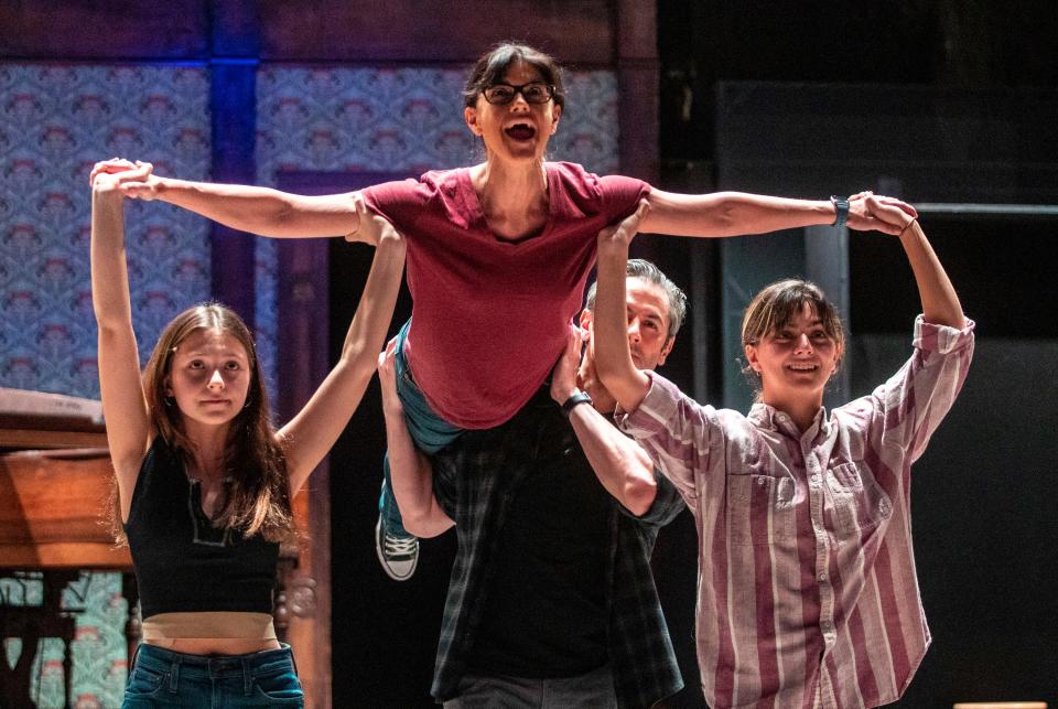 Kristen Howe, performing as adult Alison, is lifted by the younger Alisons played by Keeley Karsten (left) and Cecily Dowd as well as Victor Wallace, playing Bruce, during a rehearsal for "Fun Home" at the Coachella Valley Repertory in Cathedral City, Calif., Friday, Dec. 2, 2022. 