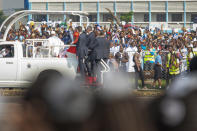 Pope Francis, left, arrives at Ndolo airport to celebrate Holy Mass in Kinshasa, Congo, Wednesday Feb. 1, 2023. Francis is in Congo and South Sudan for a six-day trip, hoping to bring comfort and encouragement to two countries that have been riven by poverty, conflicts and what he calls a "colonialist mentality" that has exploited Africa for centuries. (AP Photo/Moses Sawasawa)