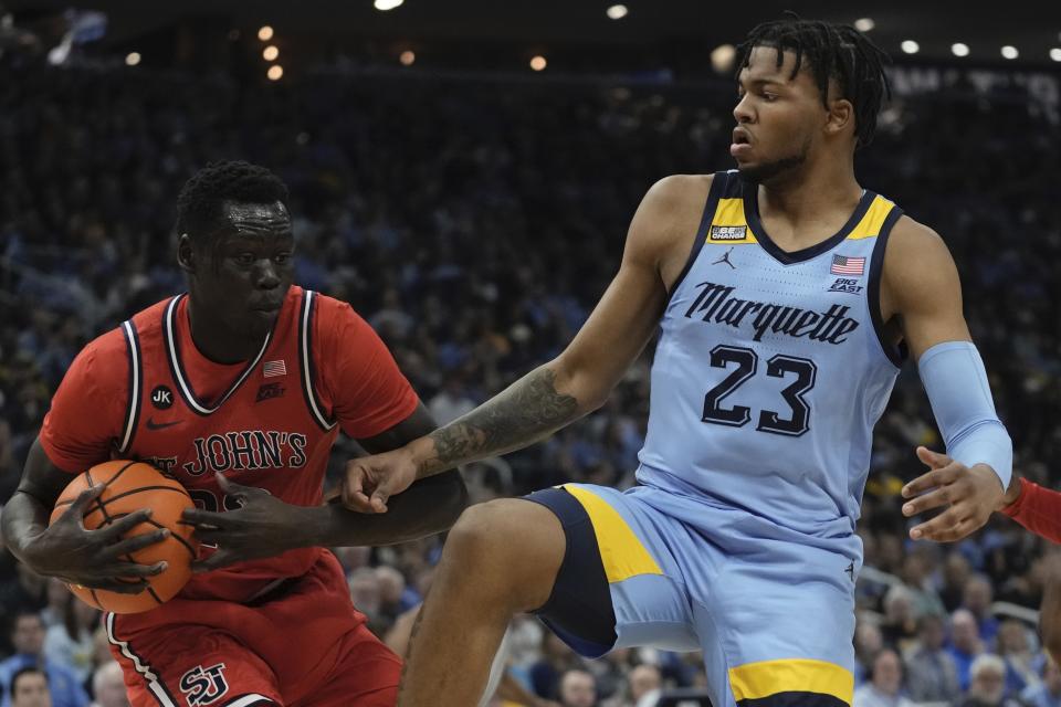 St. John's's Esahia Nyiwe rebounds in front of Marquette's David Joplin during the first half of an NCAA college basketball game Saturday, March 4, 2023, in Milwaukee. (AP Photo/Morry Gash)